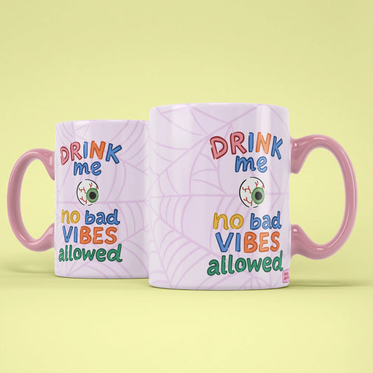 Drink Me Halloween Mug shown from both sides with pink webs