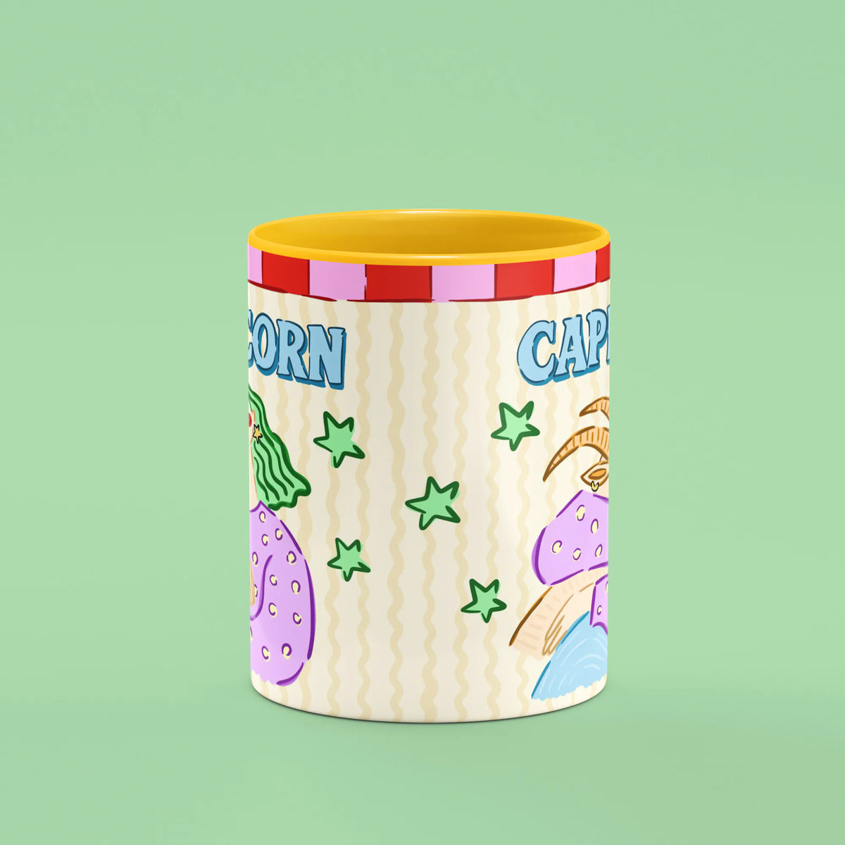 Capricorn mug reverse view showing green stars and horned goat artwork and yellow handle