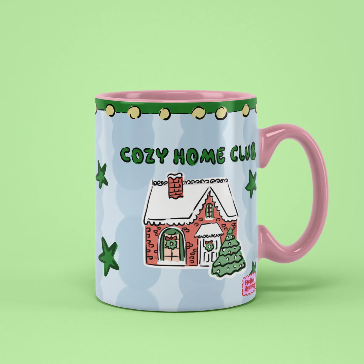Cozy Home Club Mug – winter house with green stars, pink handle on right