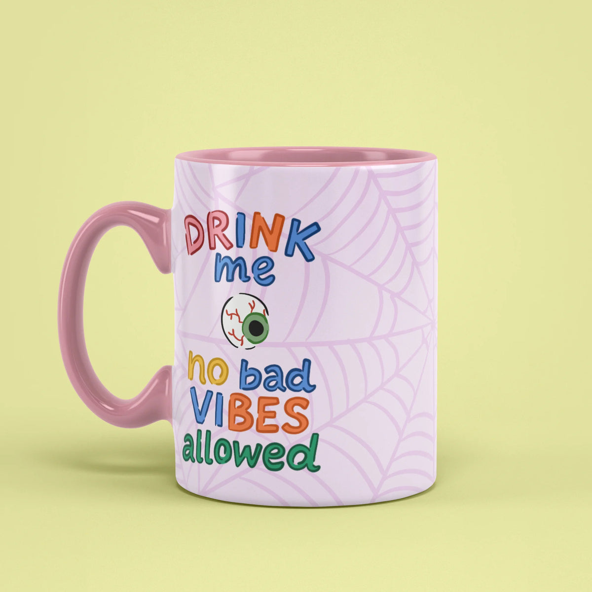 Left view of Drink Me Halloween Mug with pink handle