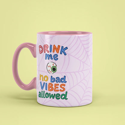 Left view of Drink Me Halloween Mug with pink handle