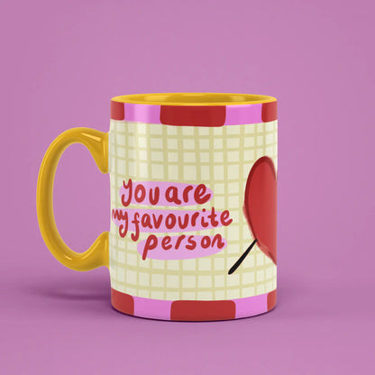 Favourite Person Mug with red heart artwork and a yellow handle on the left