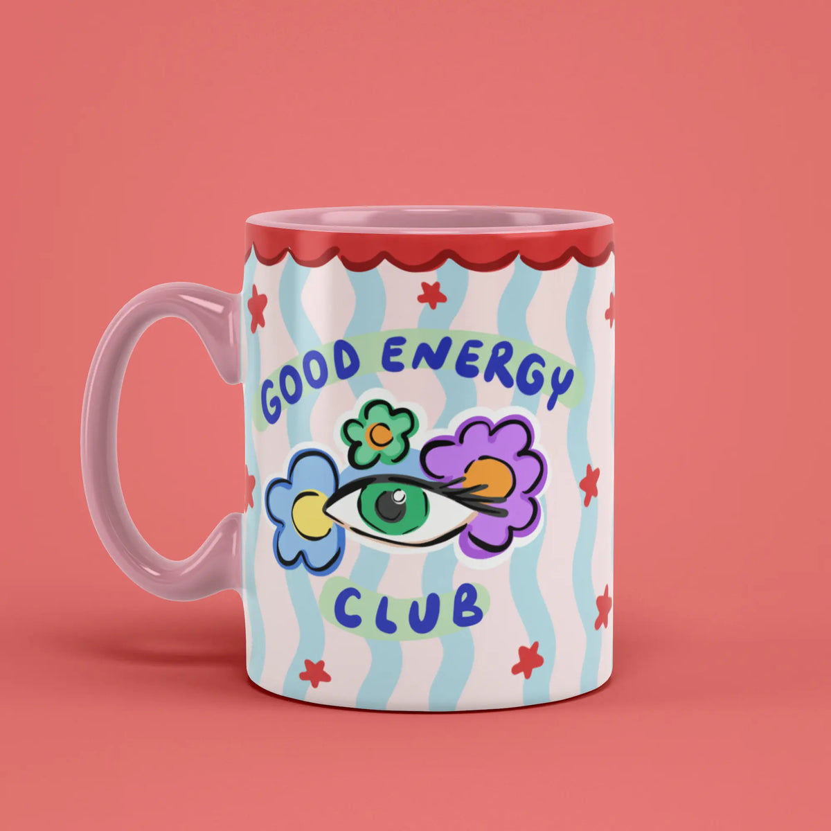 Good Energy Club Mug with playful floral artwork and a pink handle on the left