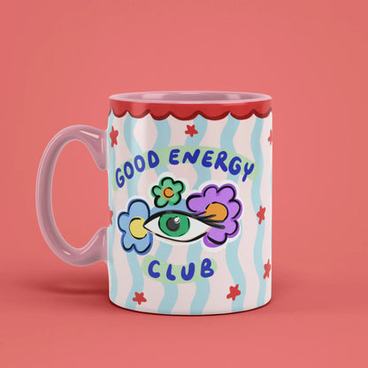 Good Energy Club Mug with playful floral artwork and a pink handle on the left