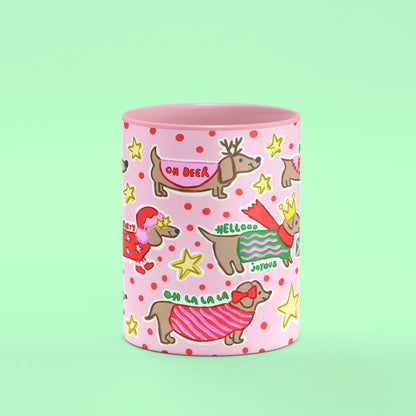 Ho Ho Ho Sausage Dog Mug – front view of sausage dogs in festive knits on pink