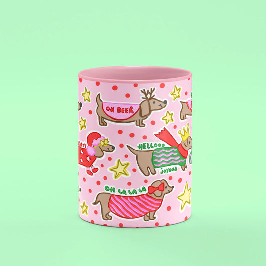 Ho Ho Ho Sausage Dog Mug – front view of sausage dogs in festive knits on pink