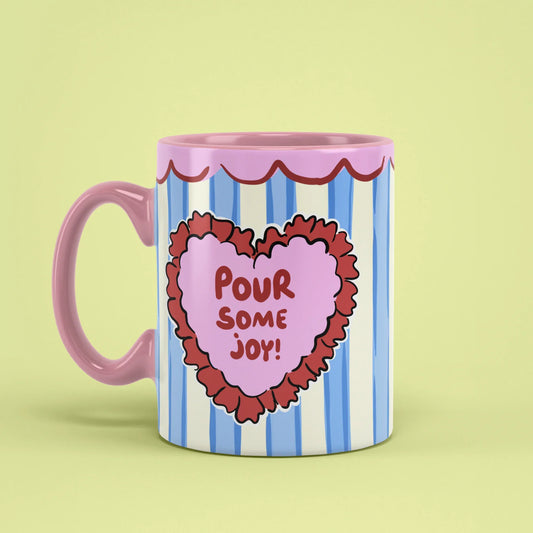 Joy Mug – scalloped rim cup with pink handle on left