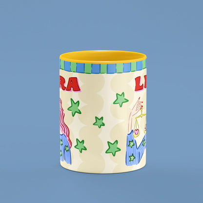 Libra mug reverse view showing green stars and golden scales and yellow handle