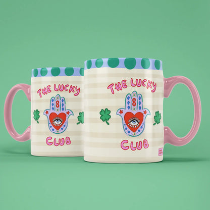 Two Lucky Club mugs showing both sides of the playful good luck design