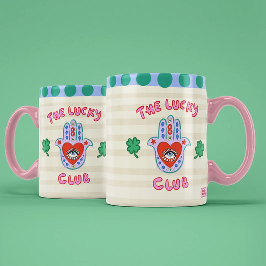 Two Lucky Club mugs showing both sides of the playful good luck design