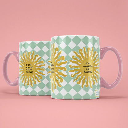 Manifest Sun Mug – golden suns with affirmations, pink handle on right