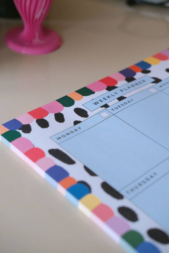 Close-up of the Rainbow weekly planner showing the writing layout and colourful spotted border.