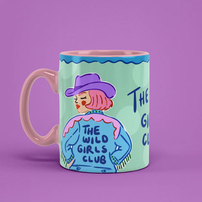 The Wild Girls Club Mug – mint green cup with denim jacket lettering, pink handle on left