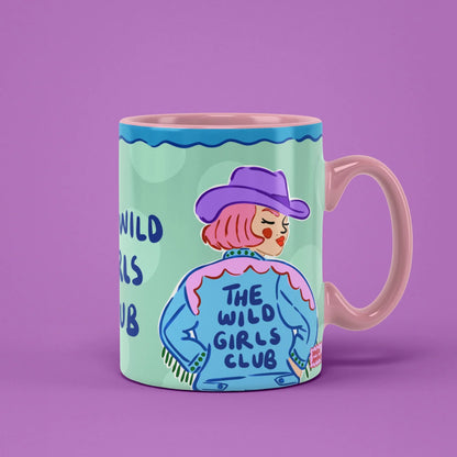 The Wild Girls Club Mug – cowgirl in a purple hat and denim jacket, pink handle on right